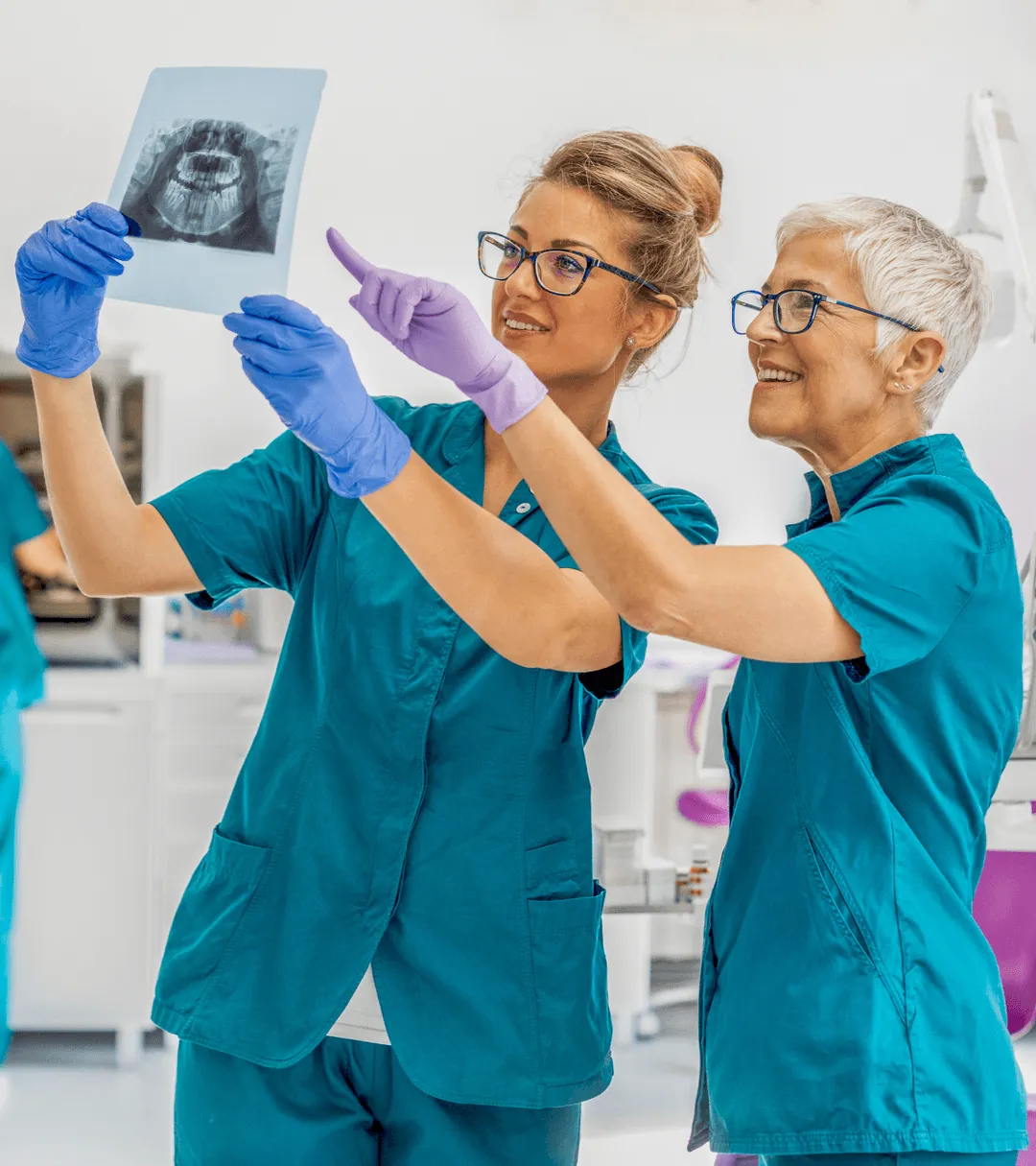 Two dentists looking at xrays.